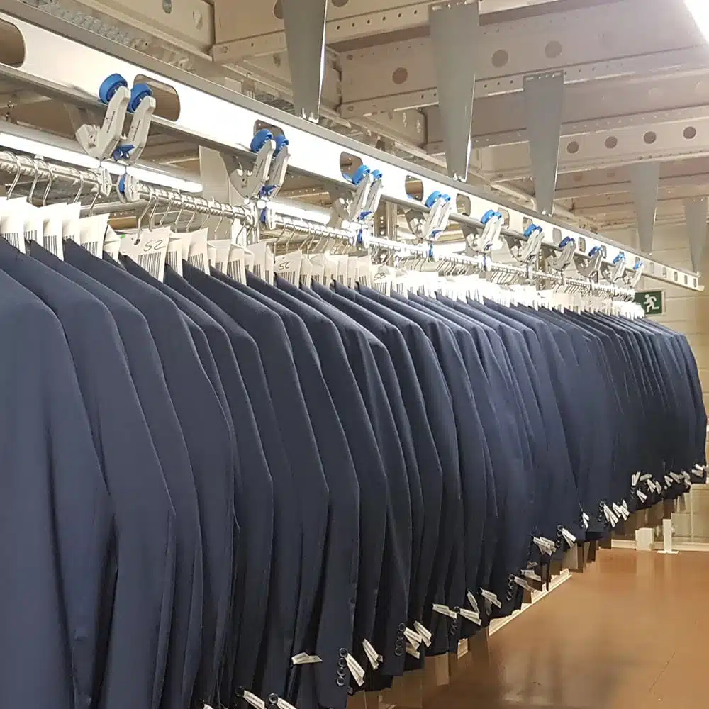 Clothing and garment logistics at Bugatti with Omniflo overhead conveyer system by Schoenenberger-Systems